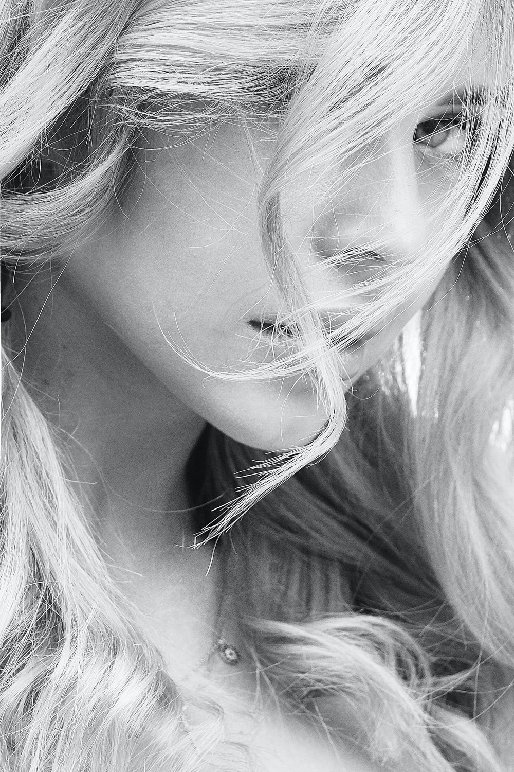 grayscale photo of woman with blonde hair photo