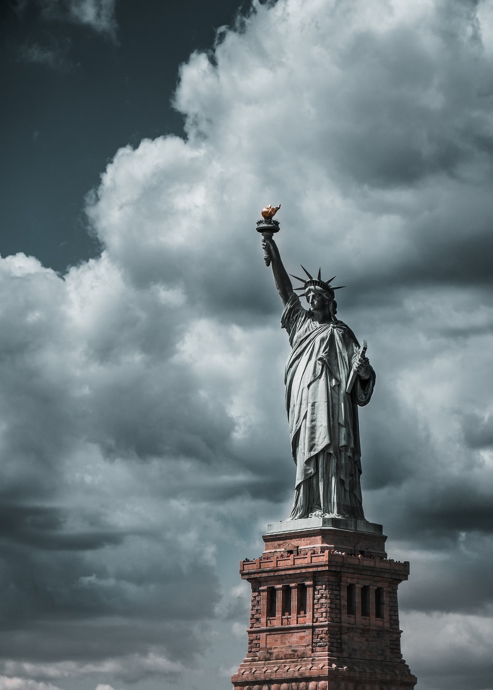Statue of Liberty under cloudy sky during daytime photo