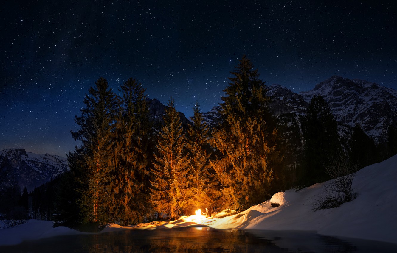 Wallpaper winter, forest, the sky, stars, light, snow, mountains, night, darkness, fire, shore, tops, people, ate, the fire, pond image for desktop, section пейзажи