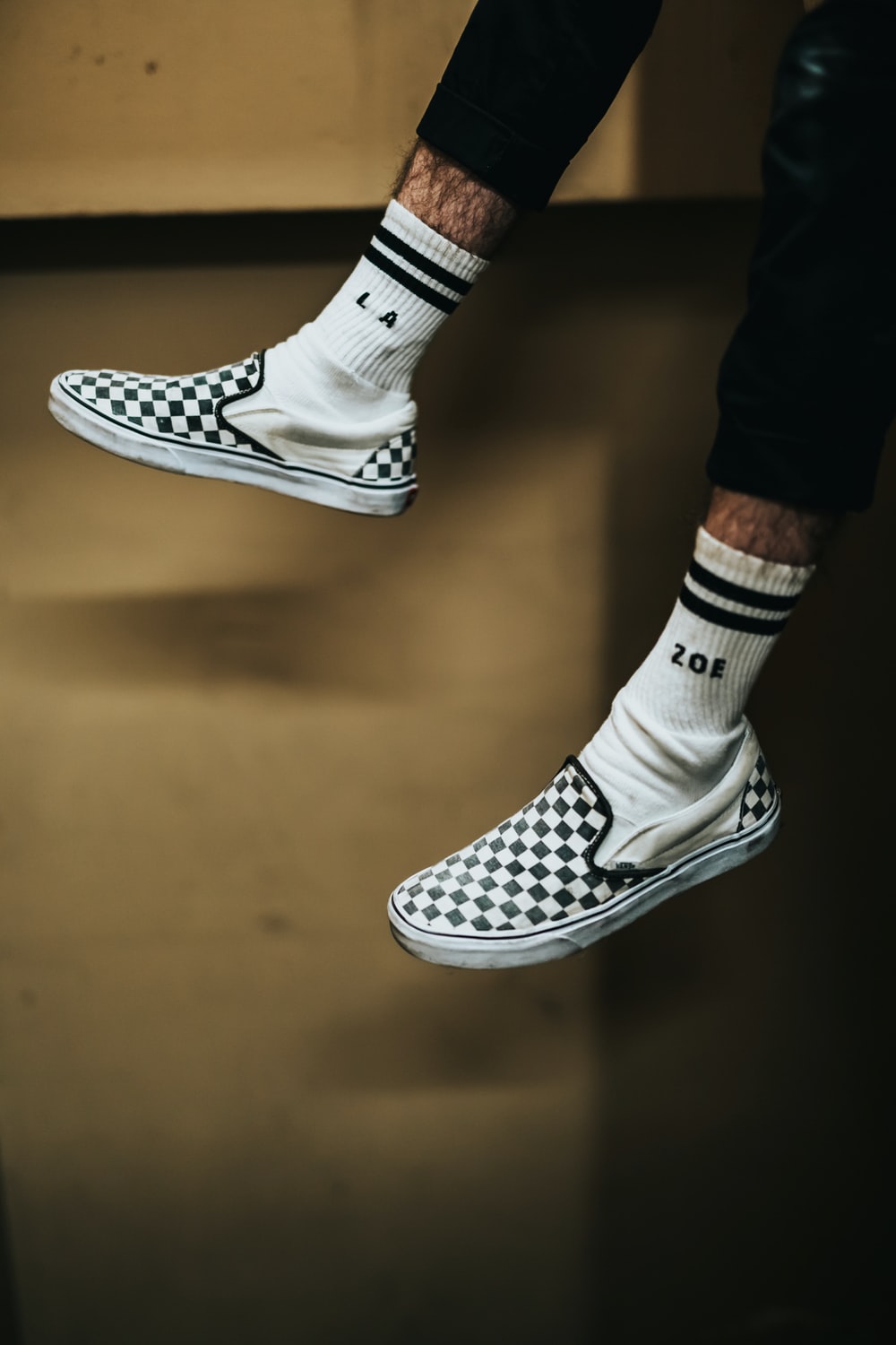 Person Wearing White And Black Checked Slip On Shoes Photo