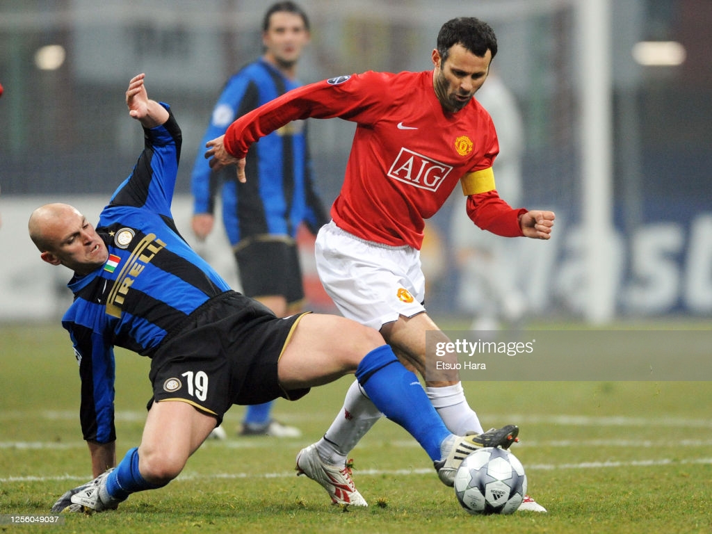 Ryan Giggs of Manchester United is tackled by Esteban Cambiasso of. News Photo