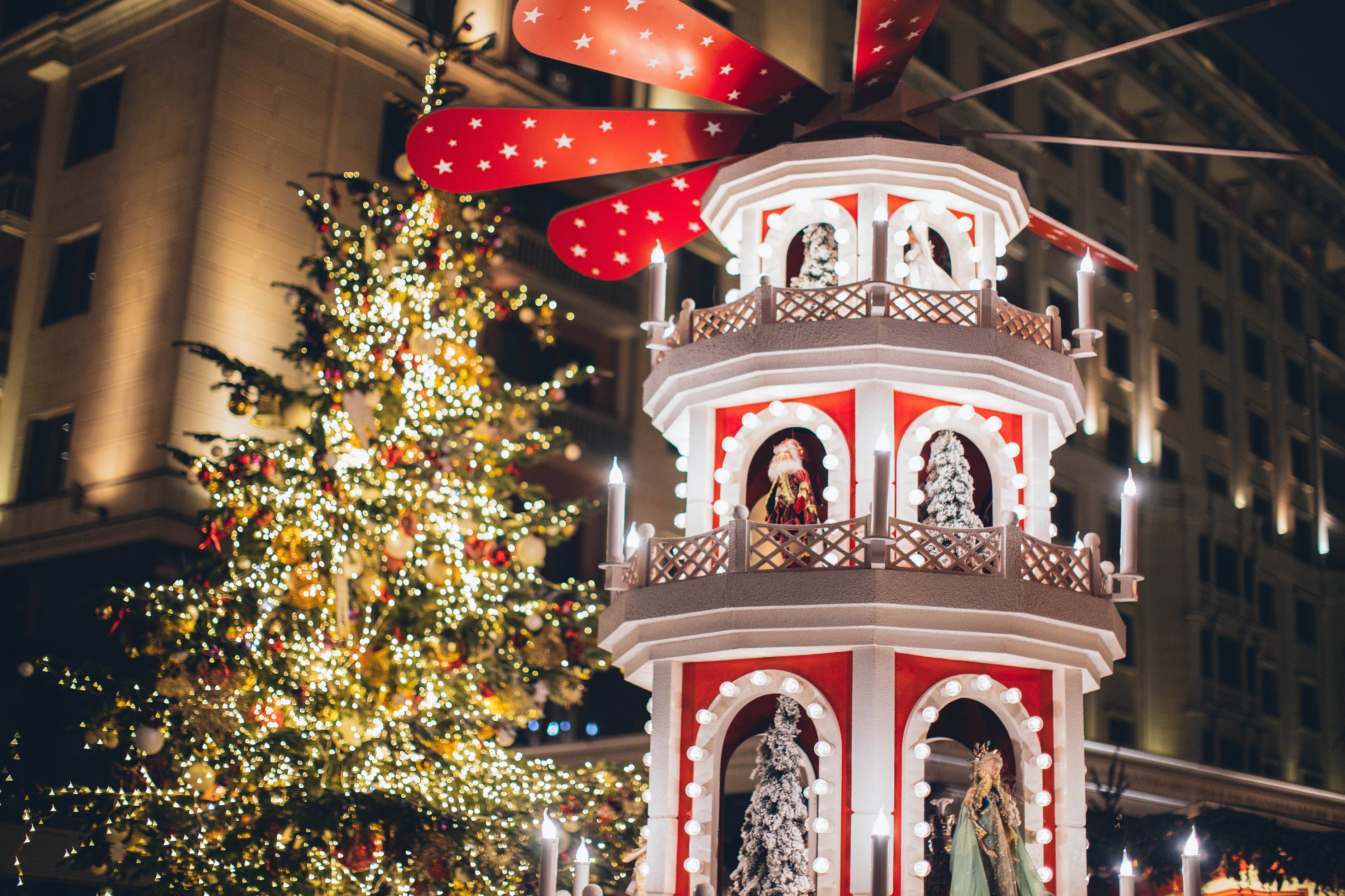 Illuminated Christmas tree and decoration in night city · Free