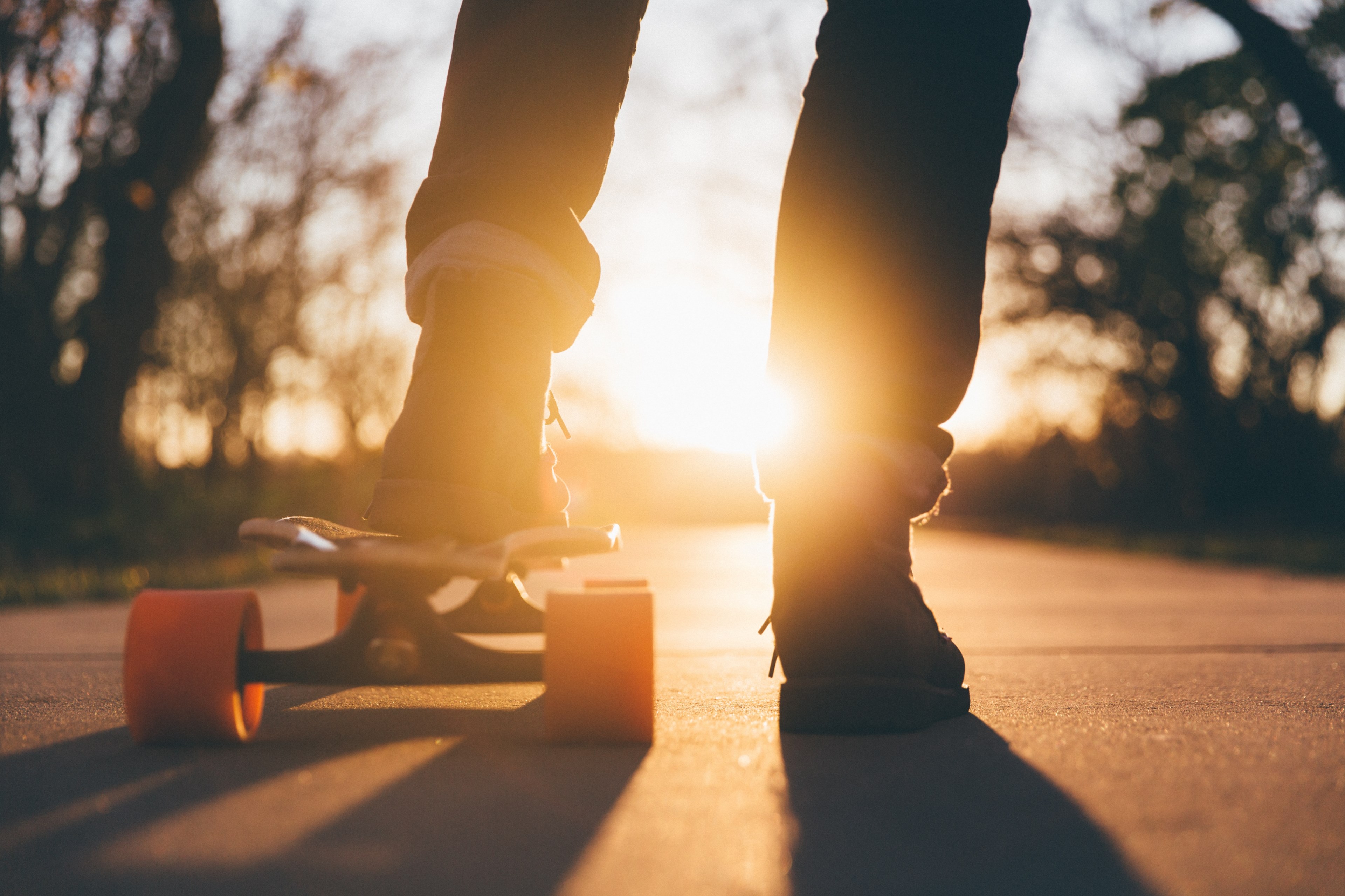 Wallpaper / the silhouette of a person riding a skateboard with orange wheels at sunset at university of northern iowa, northern iowa skateboarder 4k wallpaper