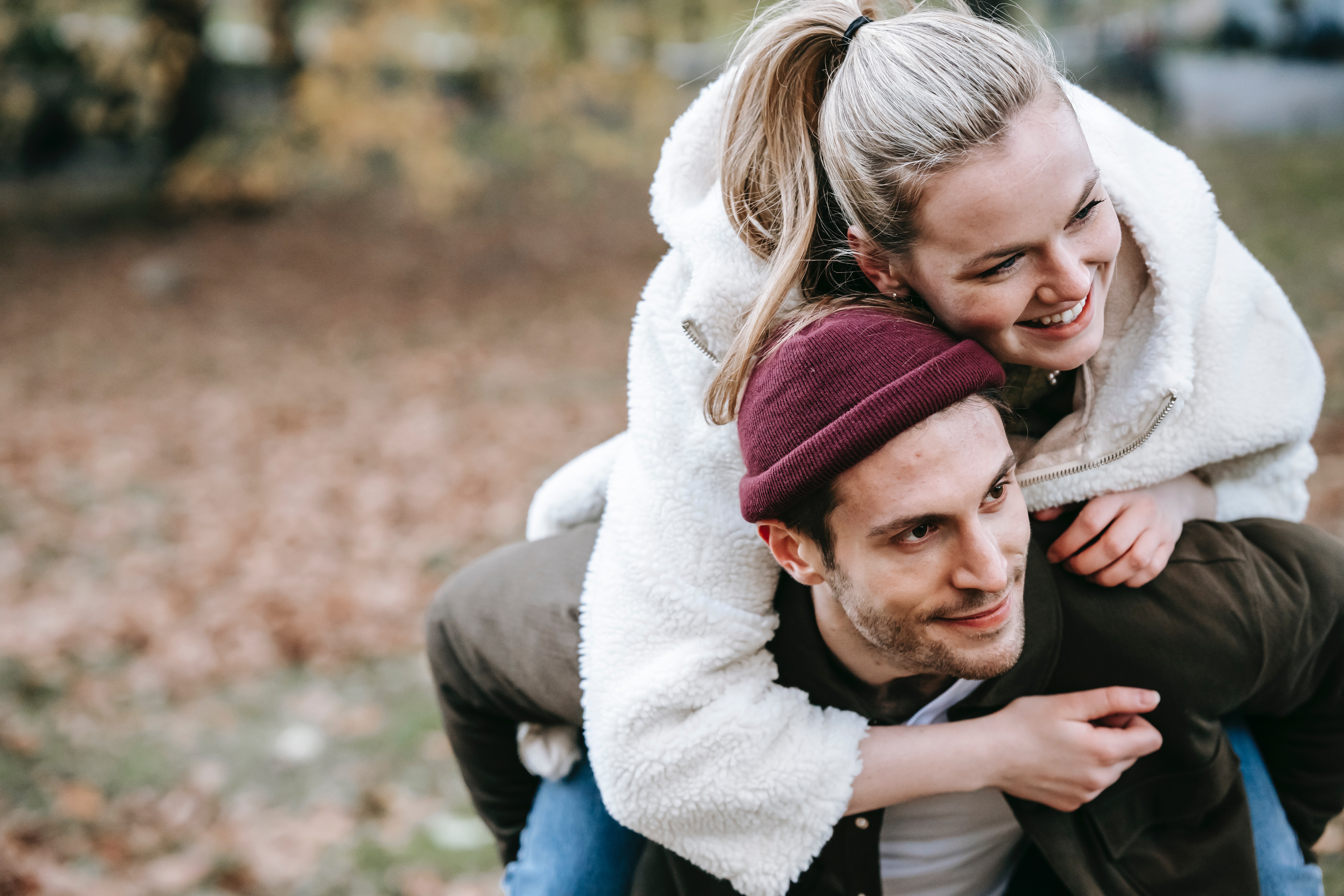 Delighted boyfriend giving piggyback ride to beloved girlfriend · Free