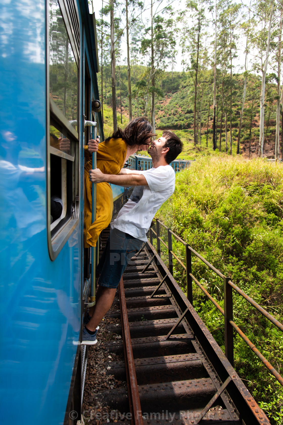 Couple kissing on a blue train in Sri Lanka, download or print for £20.01