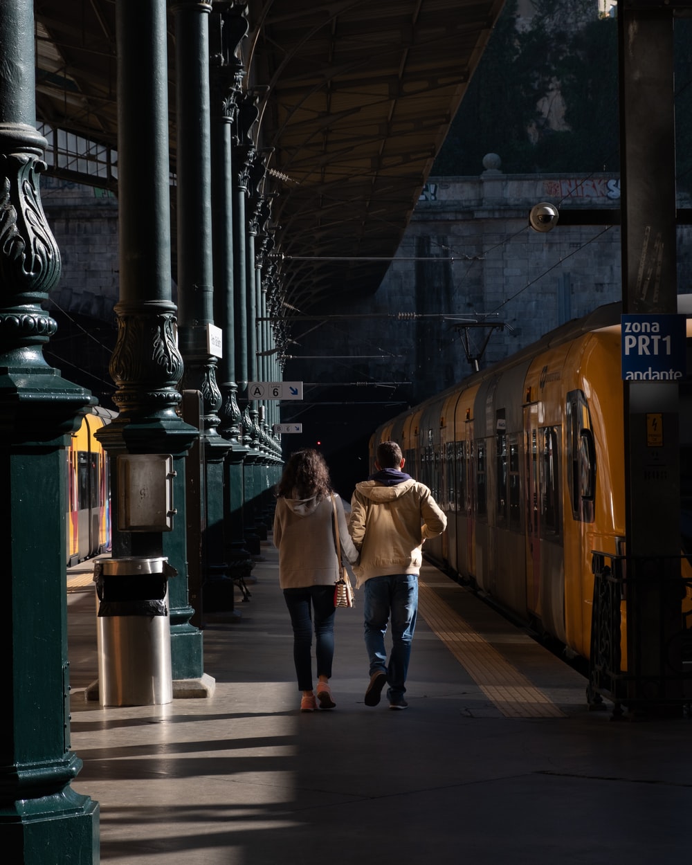 man and woman walking on train station photo