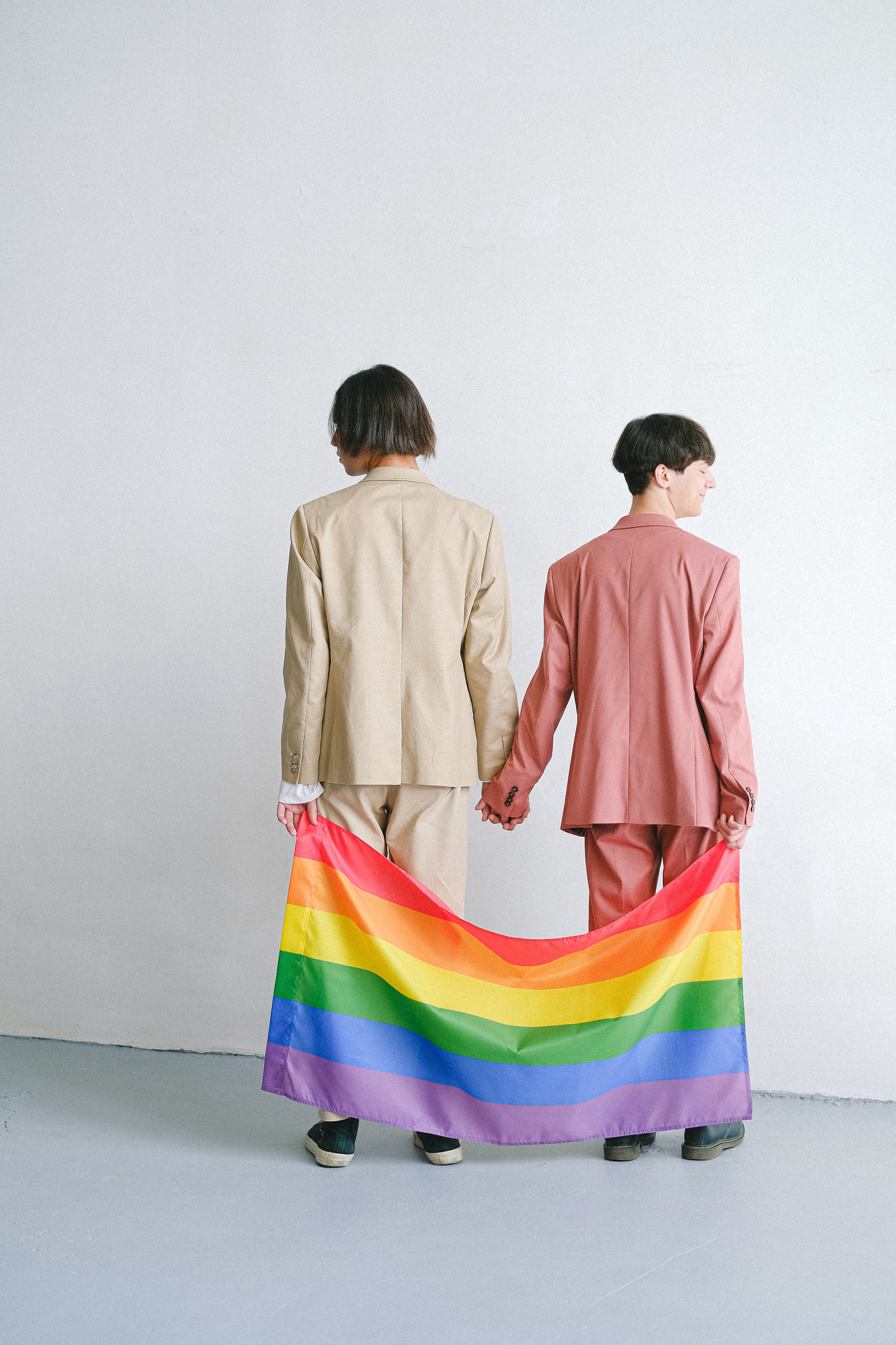 Men in Suits Holding a Gay Pride Flag · Free