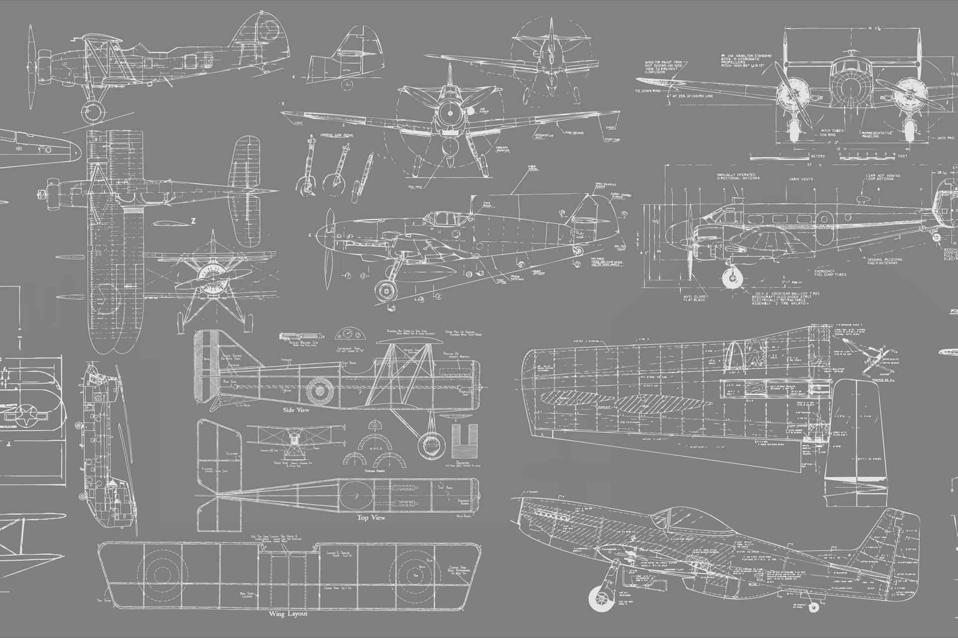 A wallpaper with a grey background and white technical drawings of airplanes. Cara Saven Wall Design