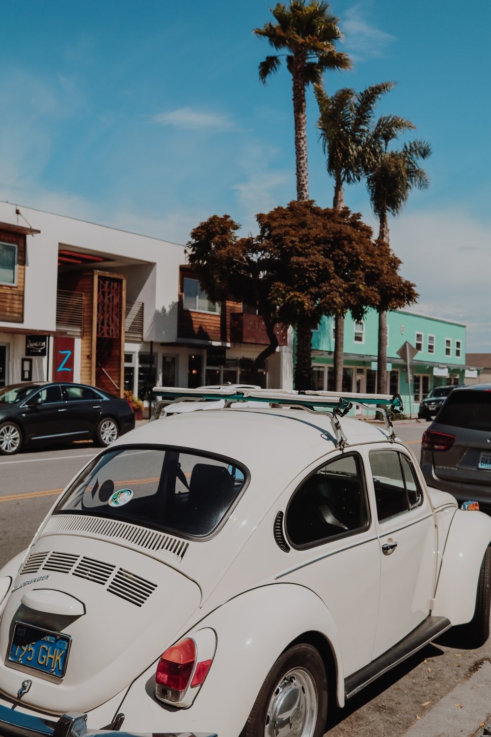 Volkswagen Beetle park beside sidewalk photo