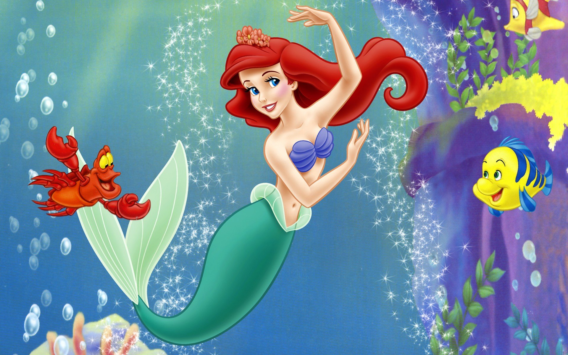 Ariel mermaid and her friends in the water
