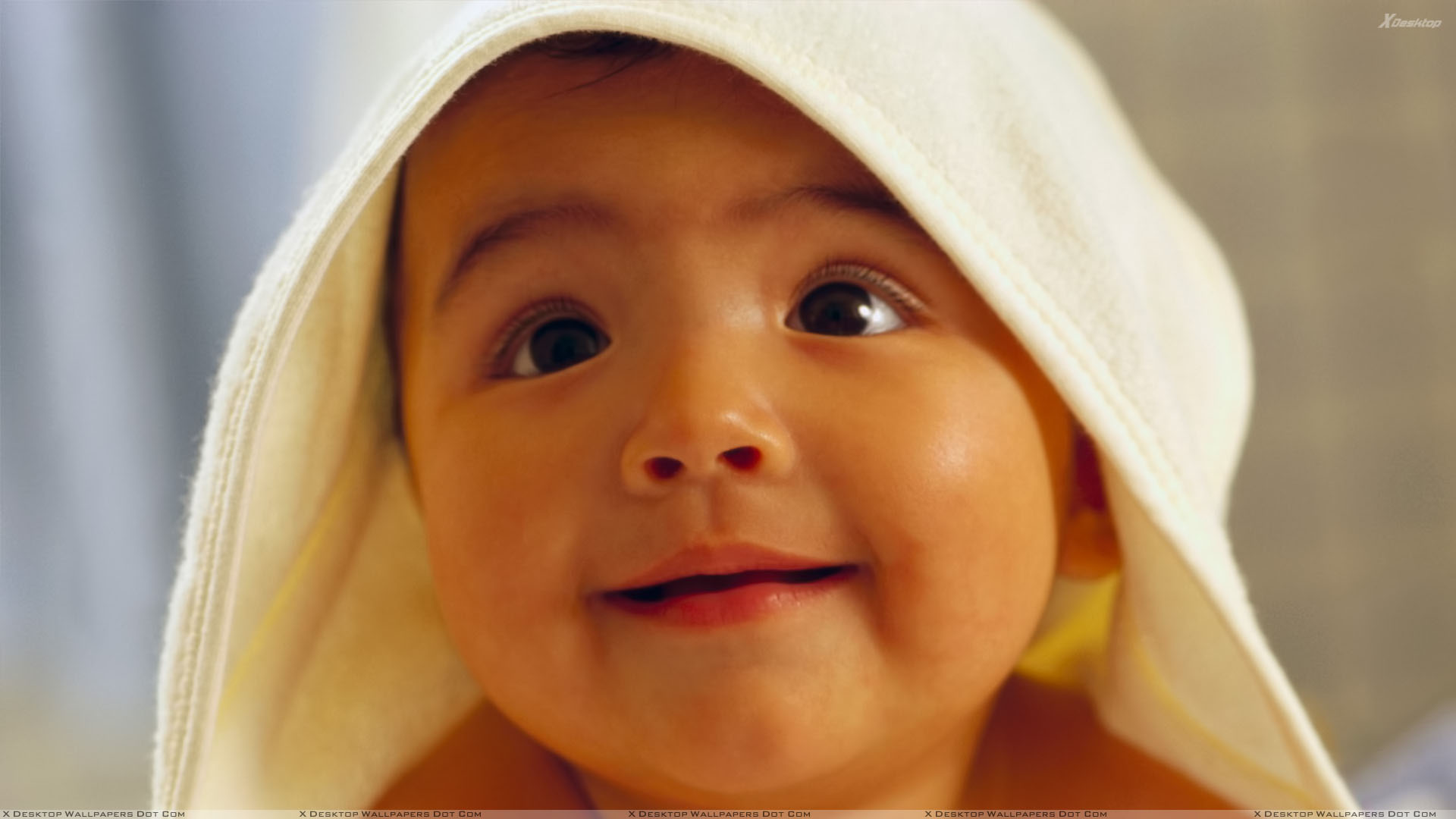 Small Kid Smiling Face Closeup in Towel Wallpaper