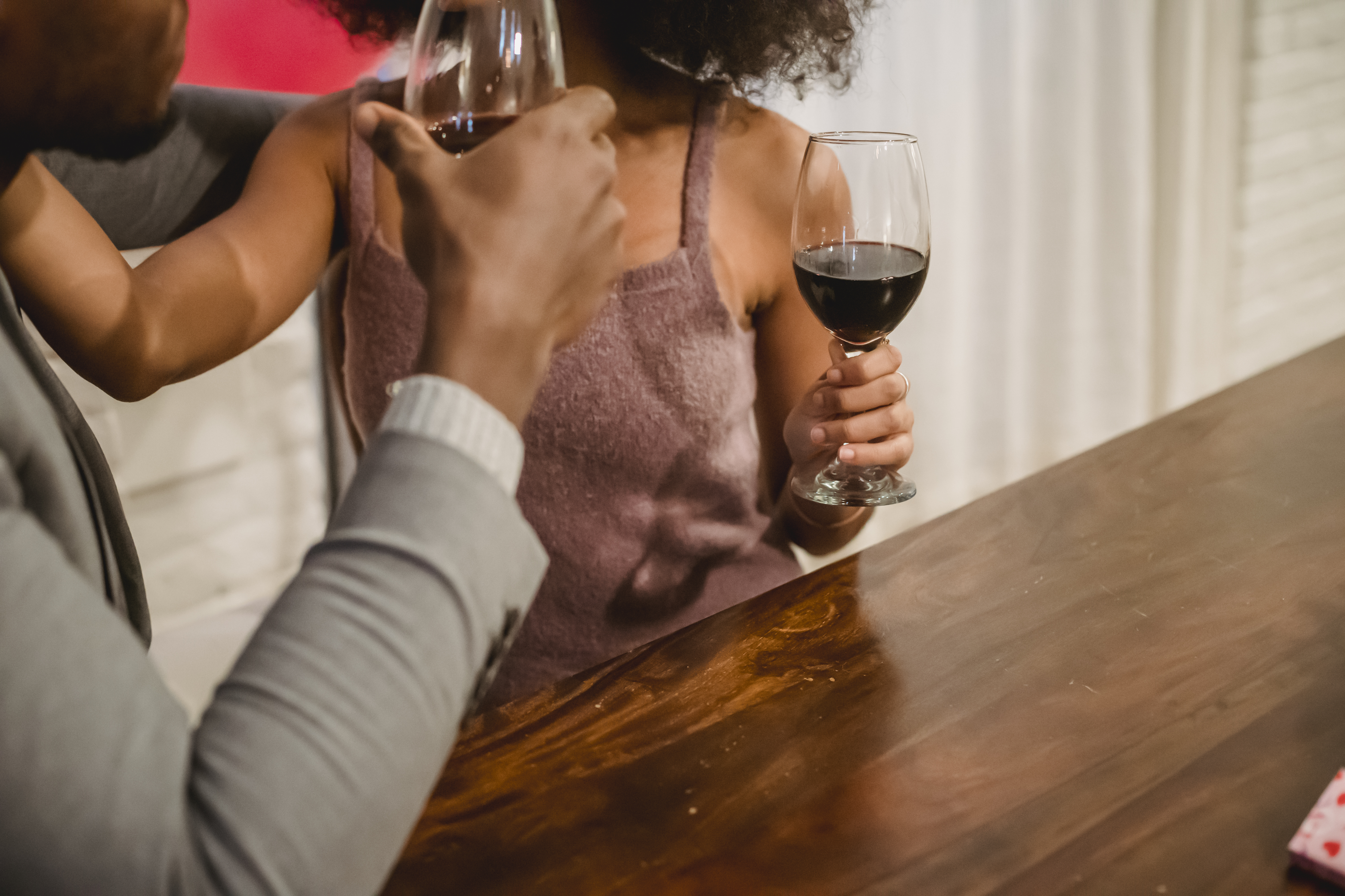 African American couple drinking wine at table · Free