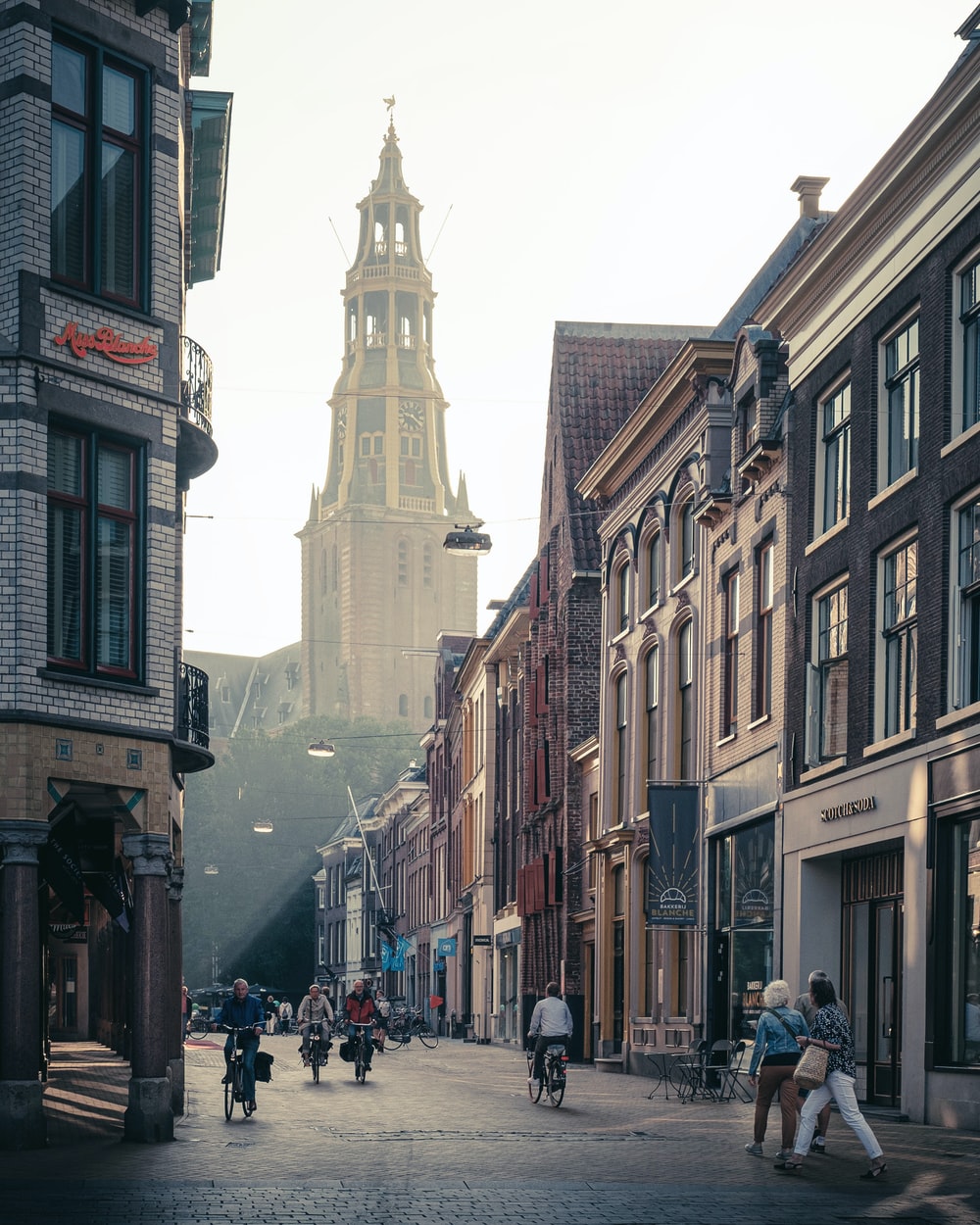 people walking on street between buildings during daytime photo