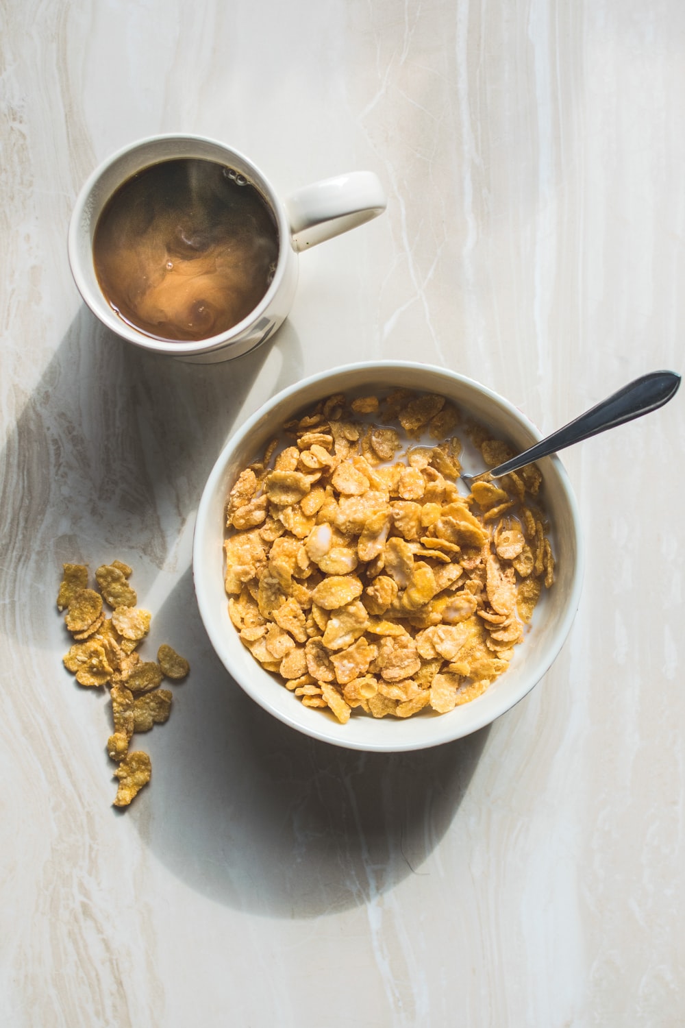 ceramic bowl filled with cereals and spoon photo