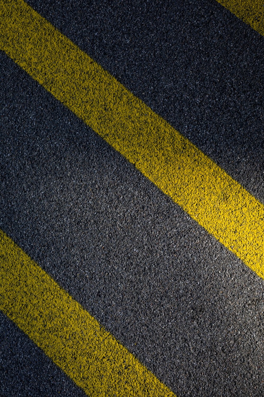 black and yellow line on gray concrete pavement photo