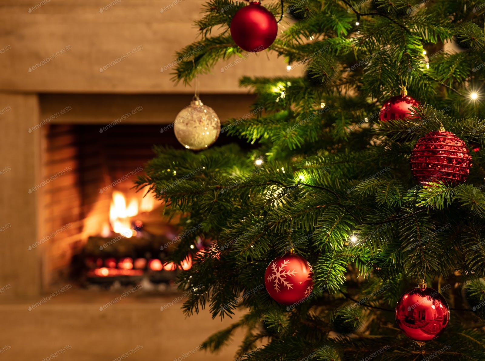Christmas tree close up on burning fireplace background photo by rawf8 on Envato Elements