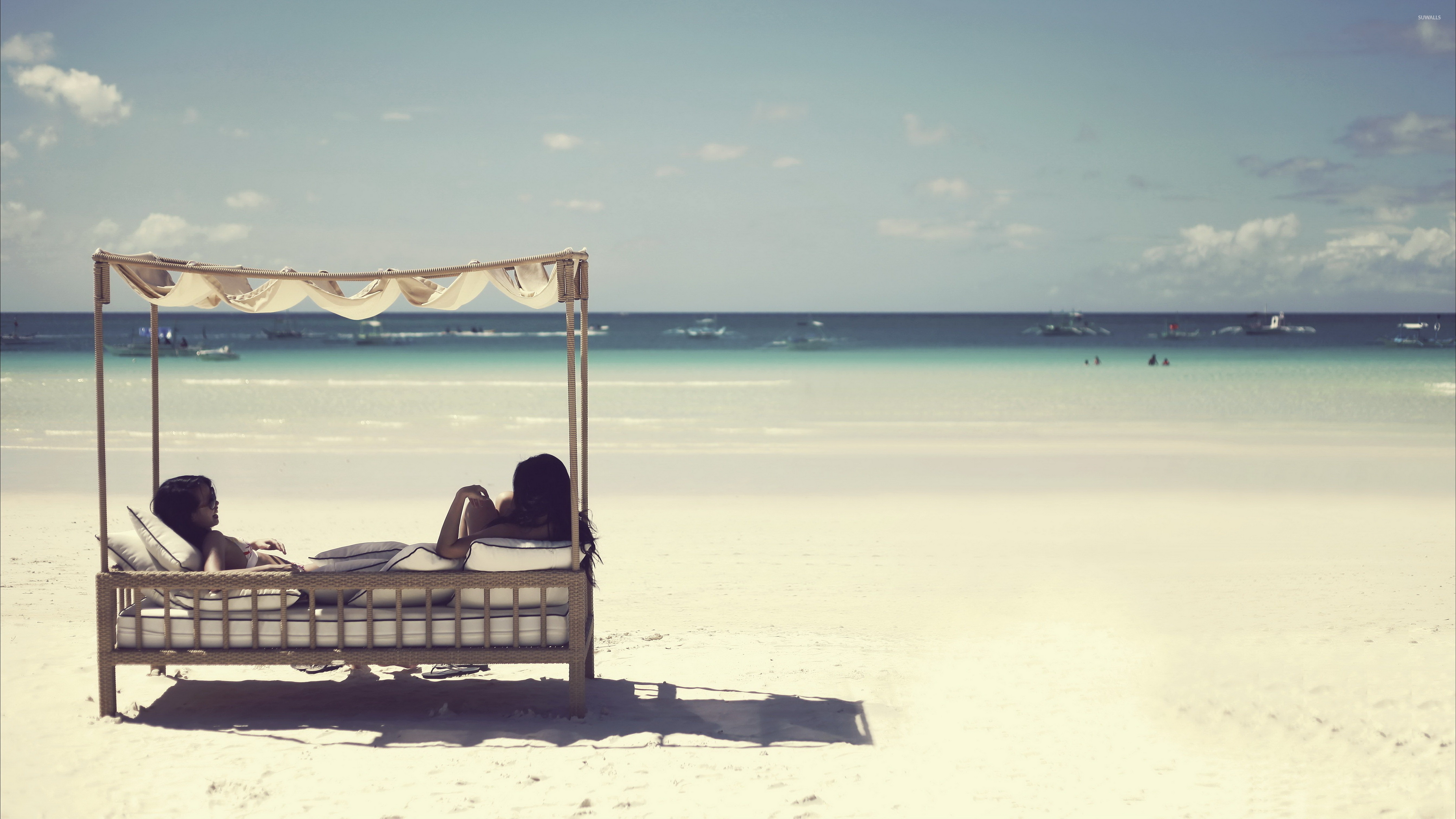 Girls relaxing on a sandy beach wallpaper wallpaper