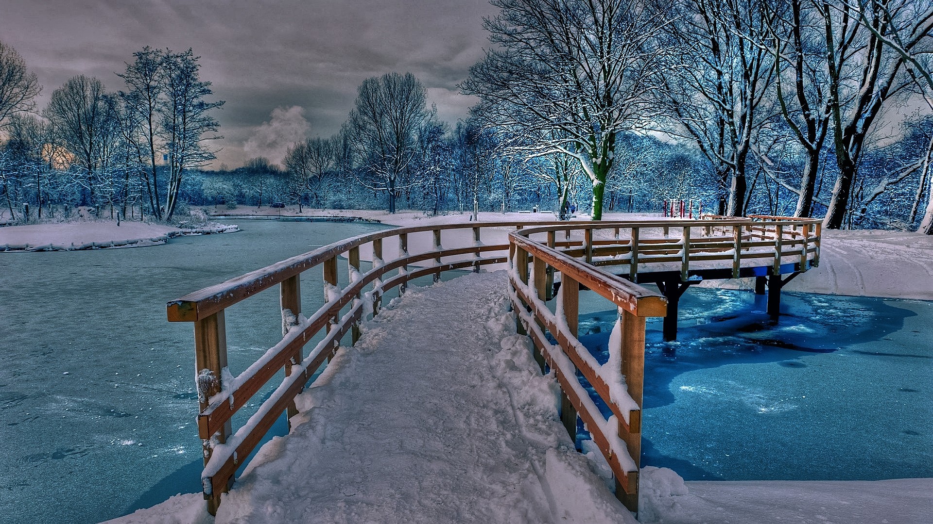 Wonderful frozen bridge over a frozen lake with blue water