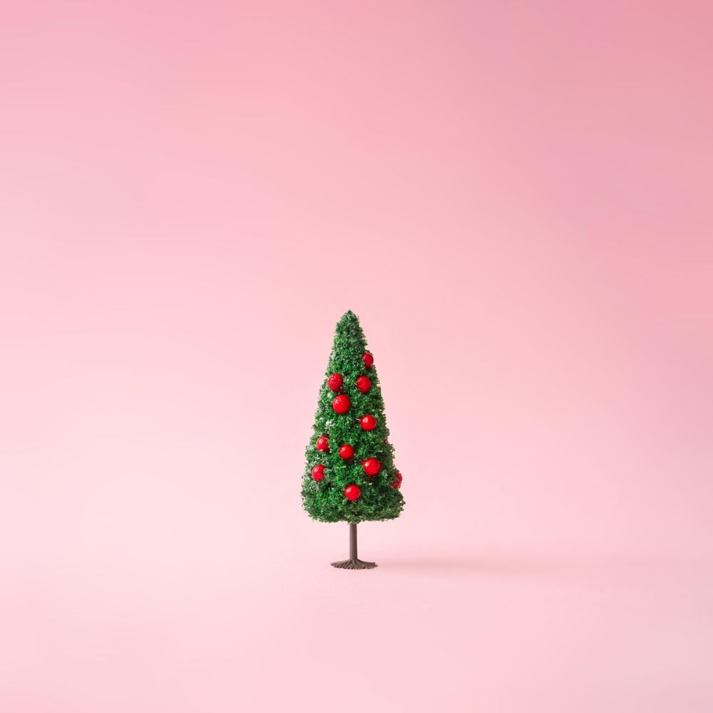 Christmas tree on pastel pink background