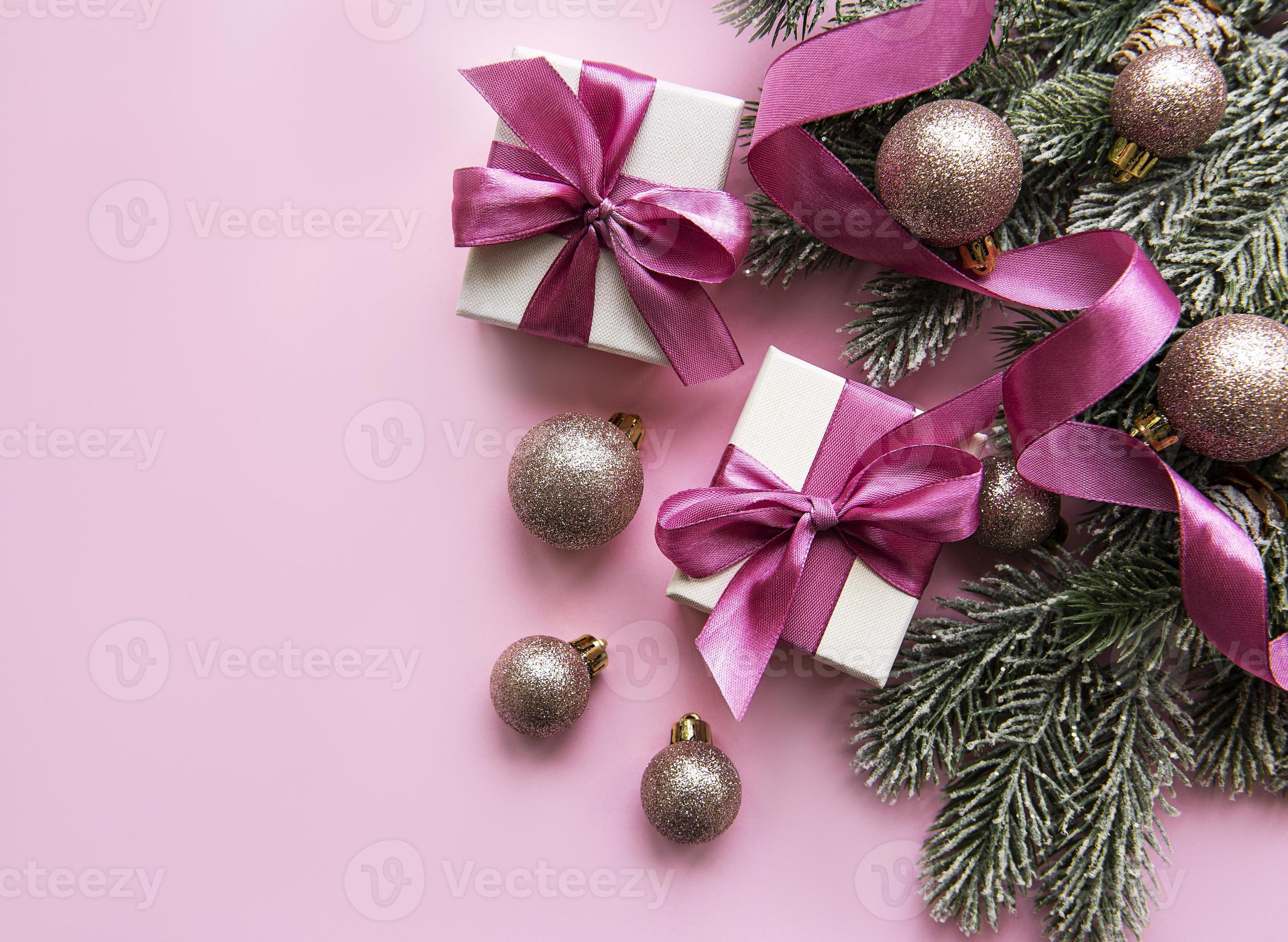 Christmas gifts, pink decorations on pastel pink background
