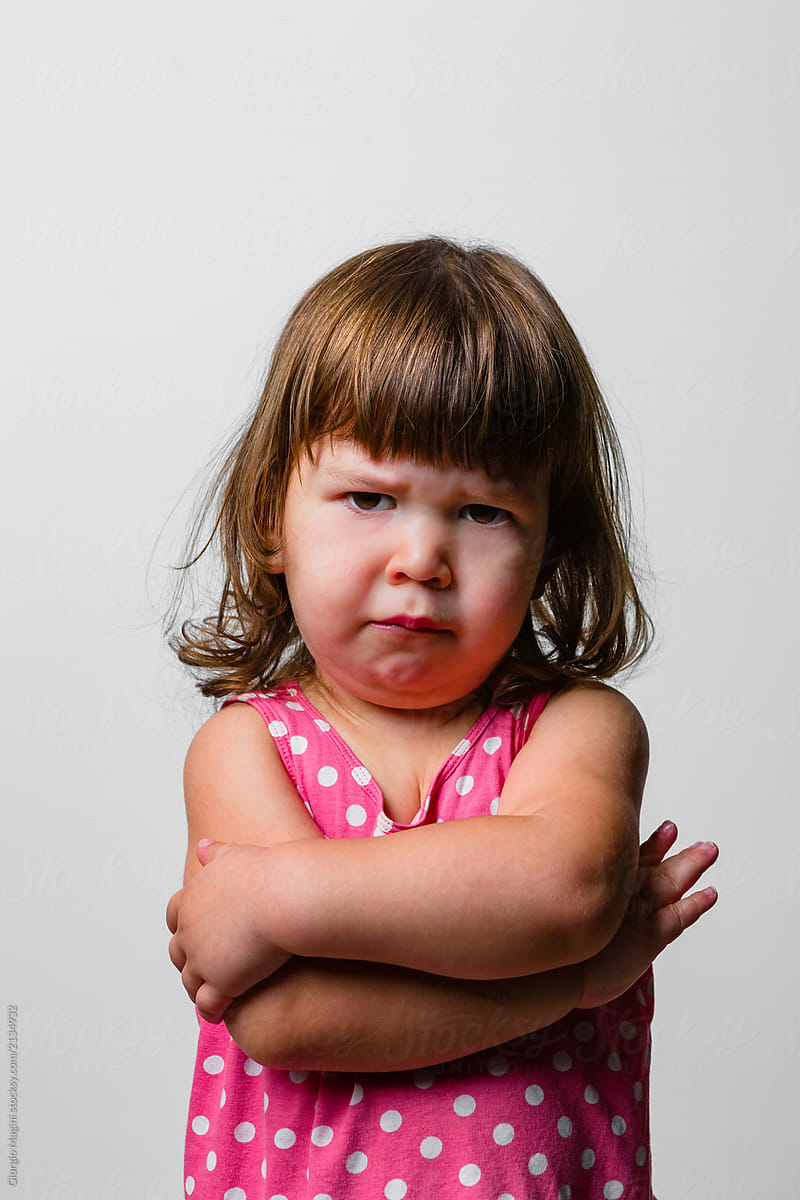 Angry Baby Girl, Studio Portrait On White Background