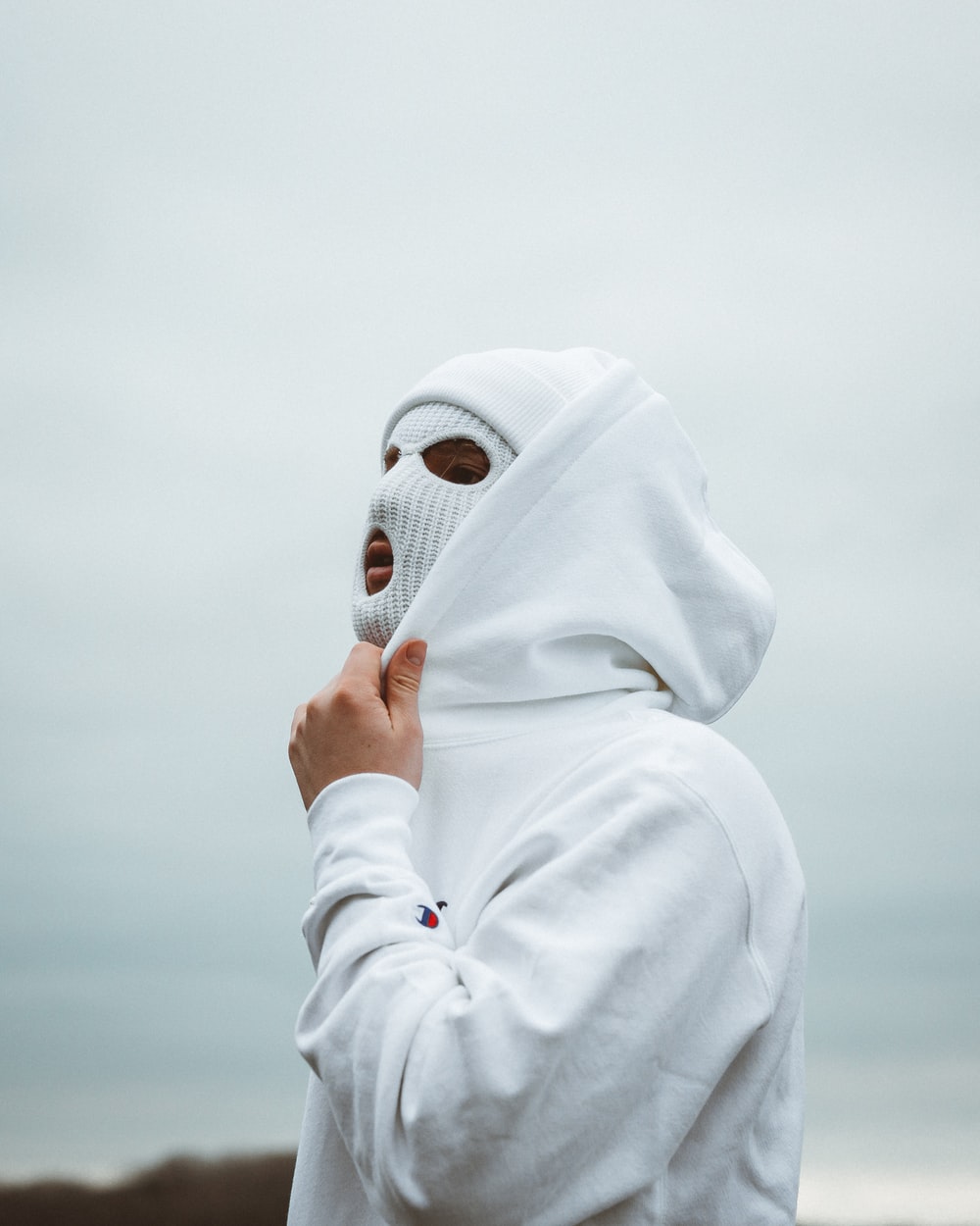 woman in white hijab covering her face with white hijab photo