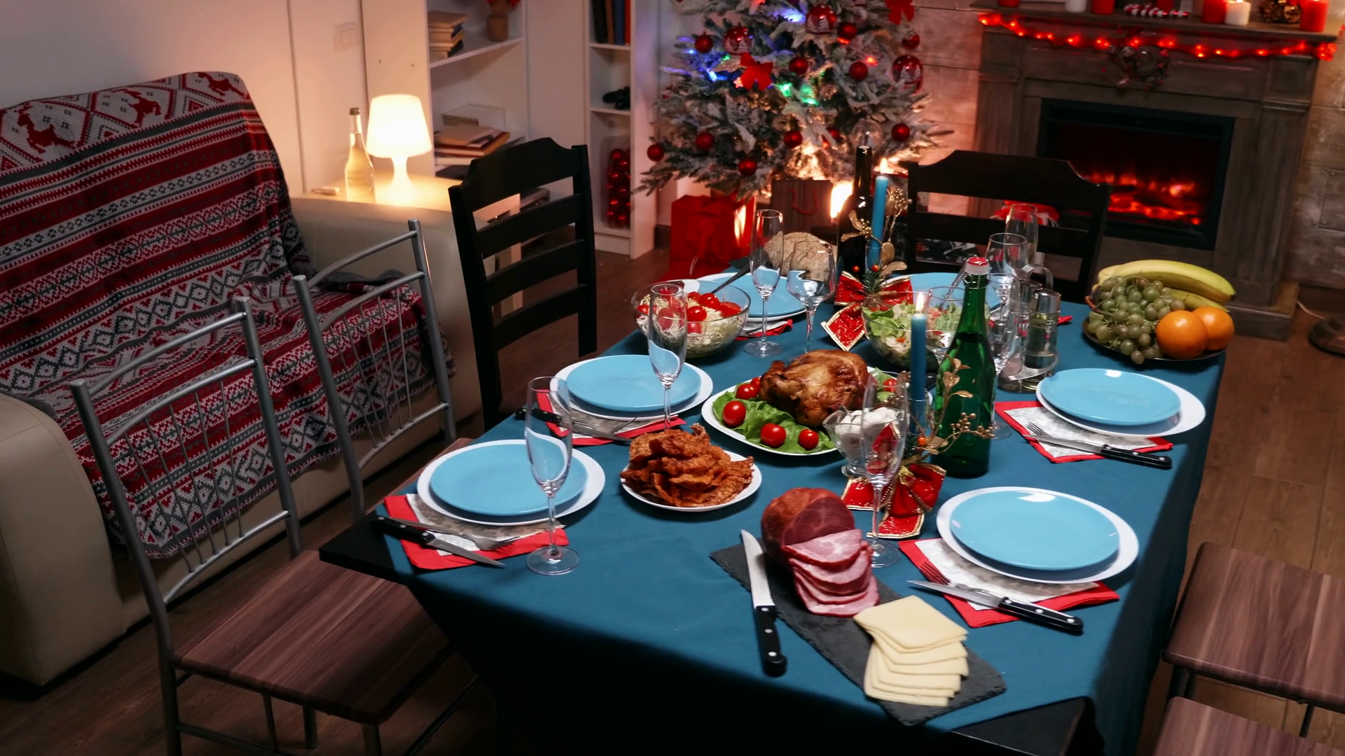 Table full of delicious and tasty food for christmas celebration of a big family. Xmas celebration in decorated room full of globe decorations and christmas tree with fireplace, big festive dinner Stock