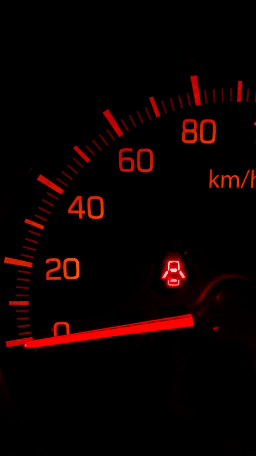black and red speedometer at 0 photo