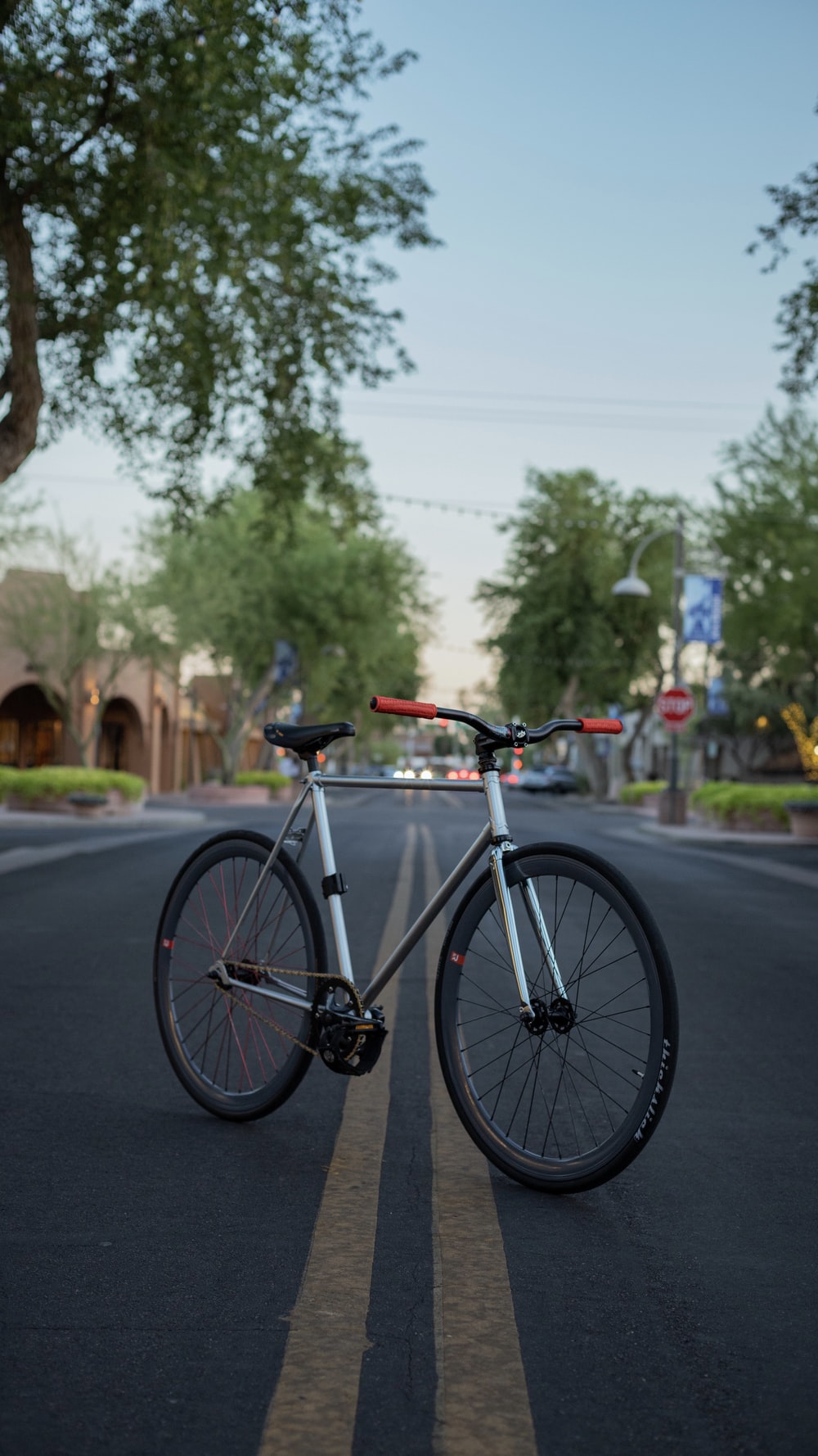 black and white road bike on road during daytime photo