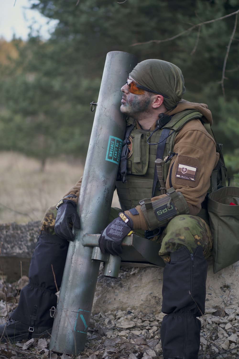 soldier man wearing tactical vest sitting while looking up photo