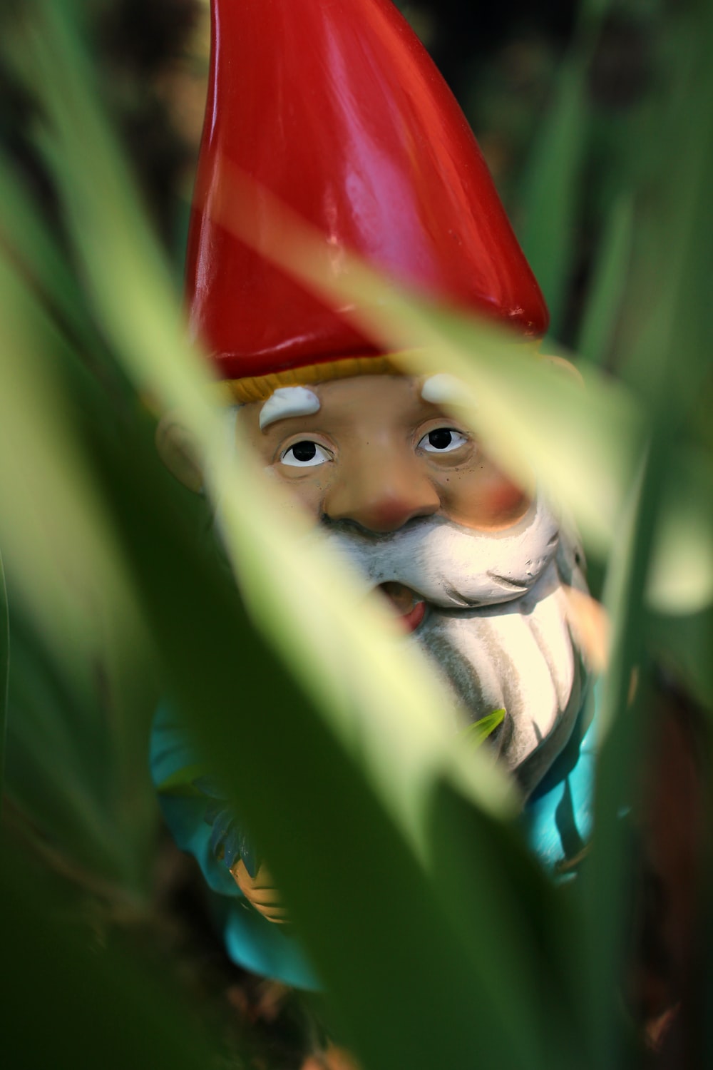 gnome standing on green grass during daytime photo