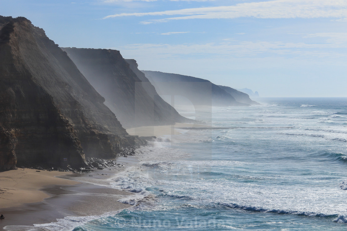 Beach with a big cliff in background in a winter day Portugal, download or print for £12.40