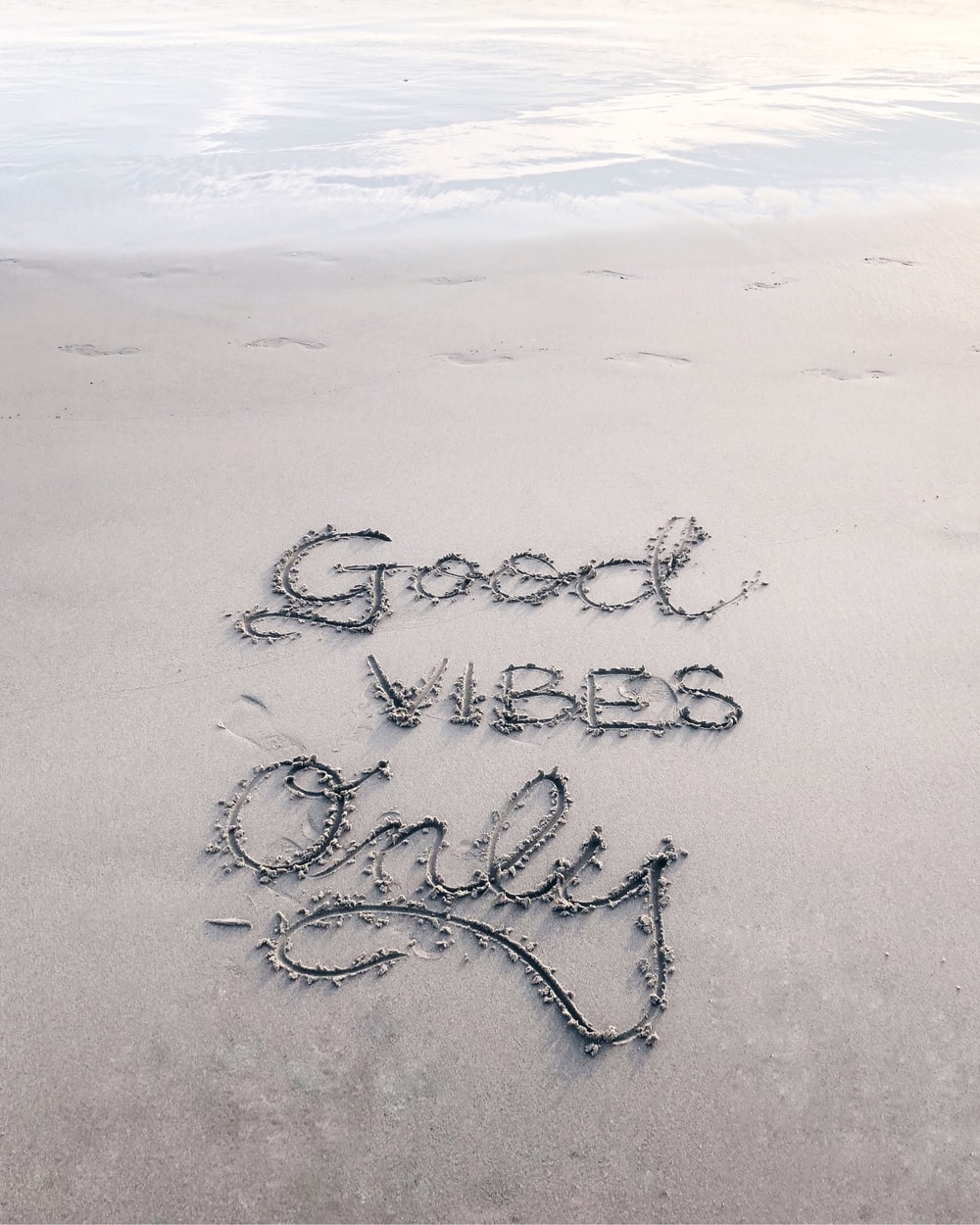 Good Vibes Only sand text photo