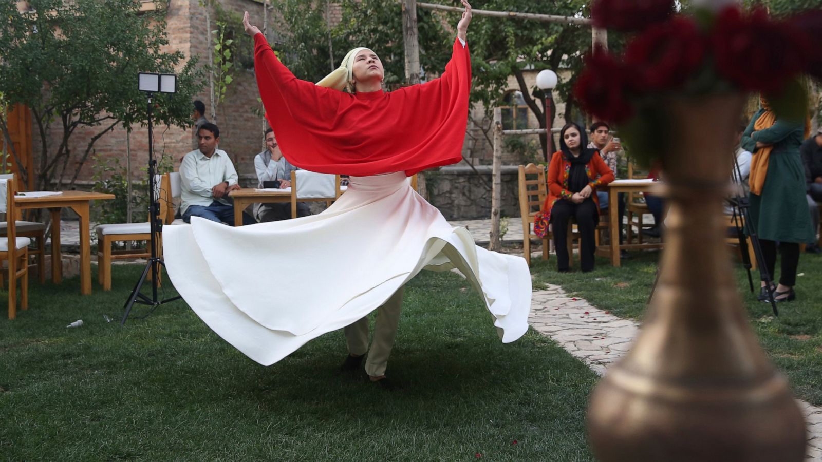 Young Afghan women, men perform whirling Sufi dance together