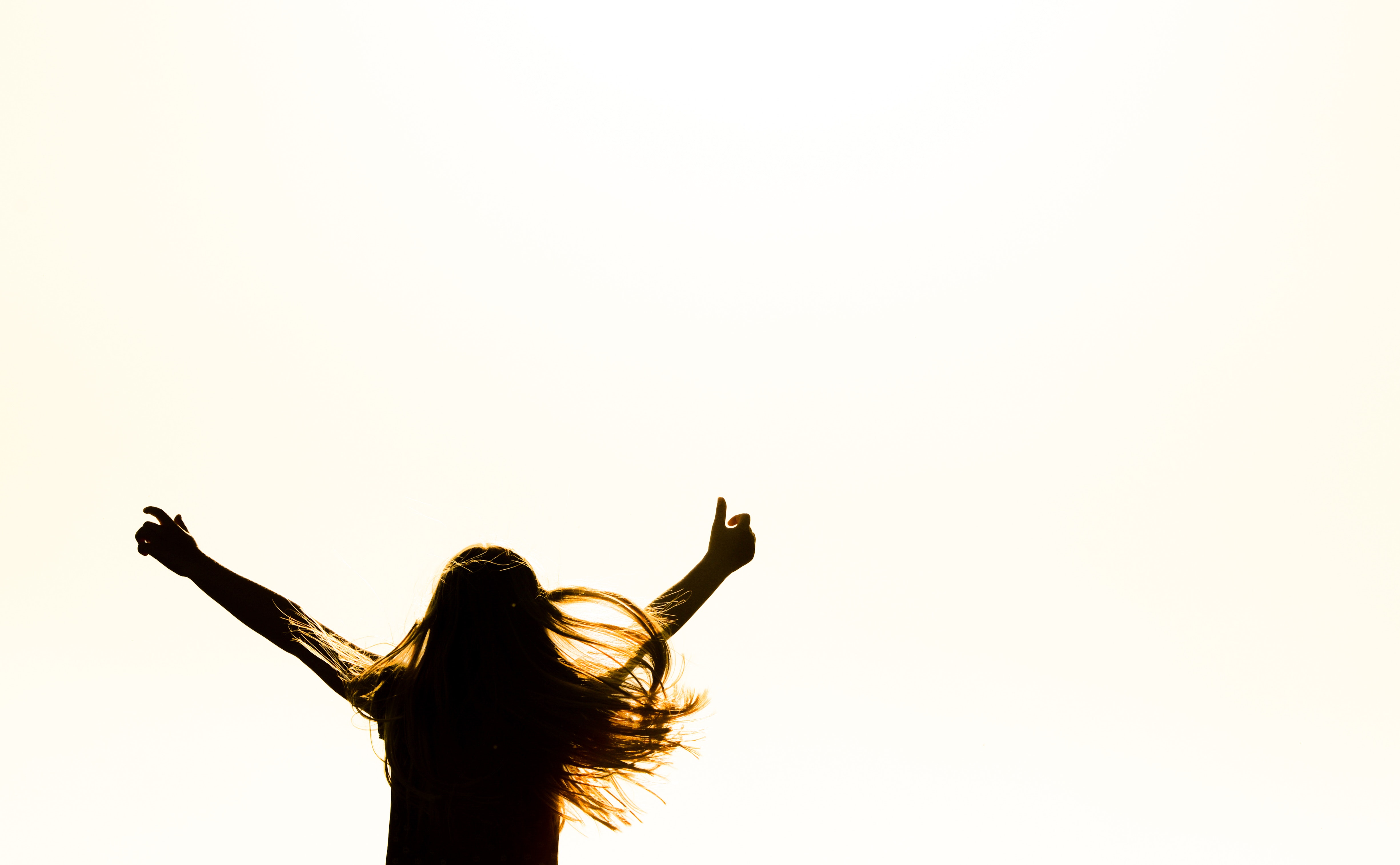 Silhouette of Woman Raising Her Hands · Free