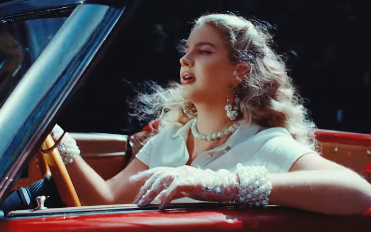 Lana Del Rey Features Controversial Mesh Mask in 'Chemtrails Over the Country Club' Music Video