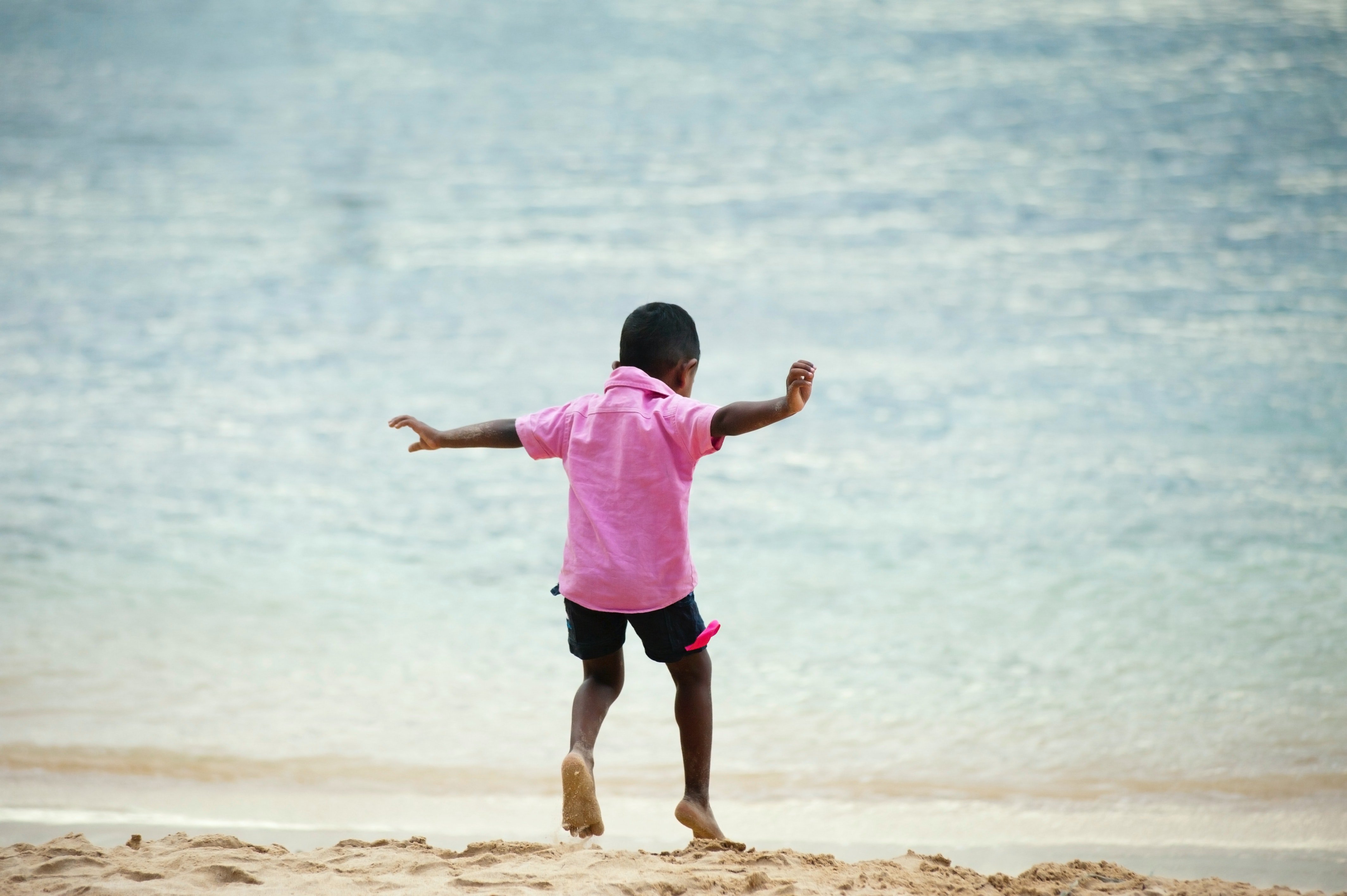 Boy Wearing Pink Collared Shirt Running on Seashore · Free