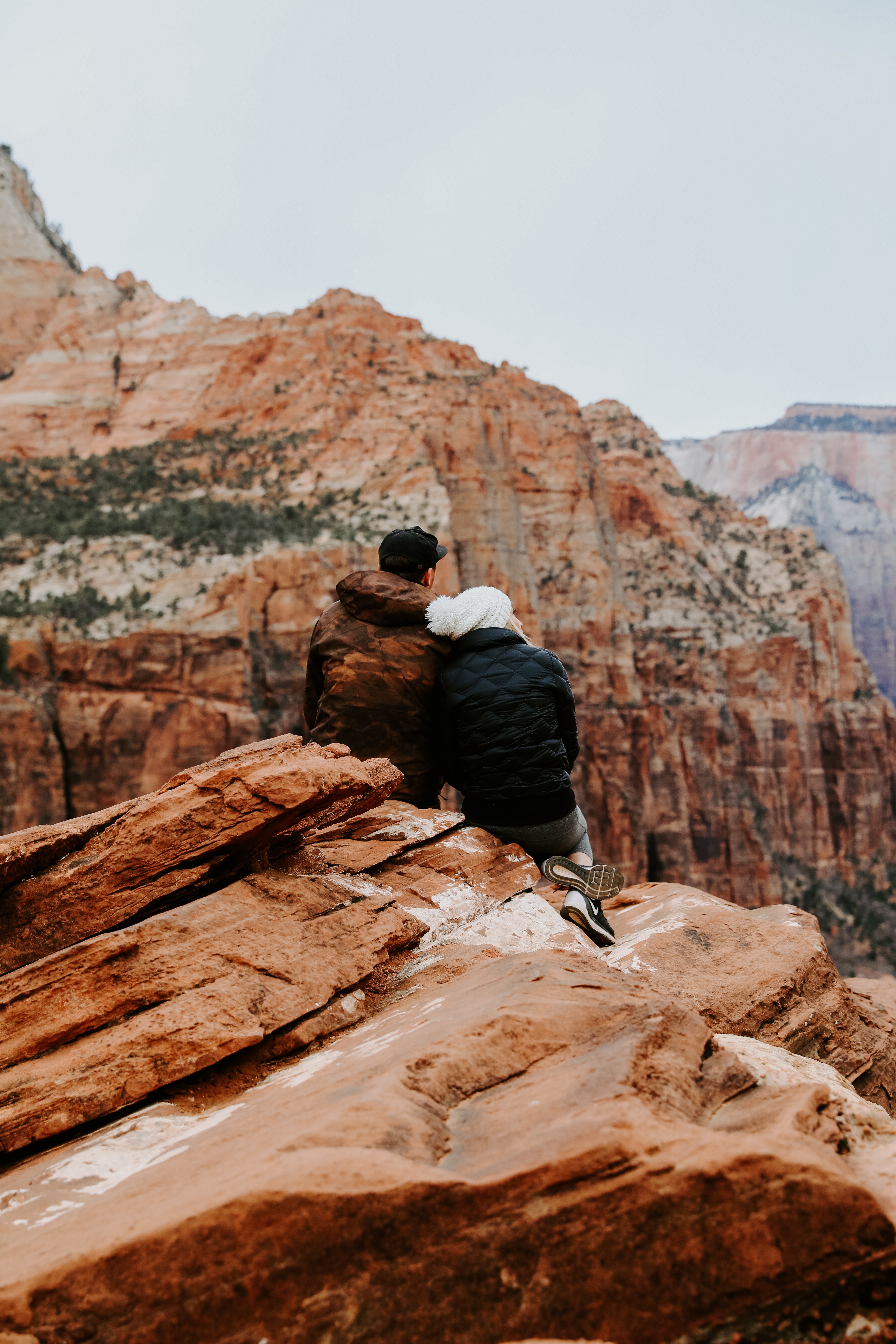 Couple Sitting on Rock Cliff · Free