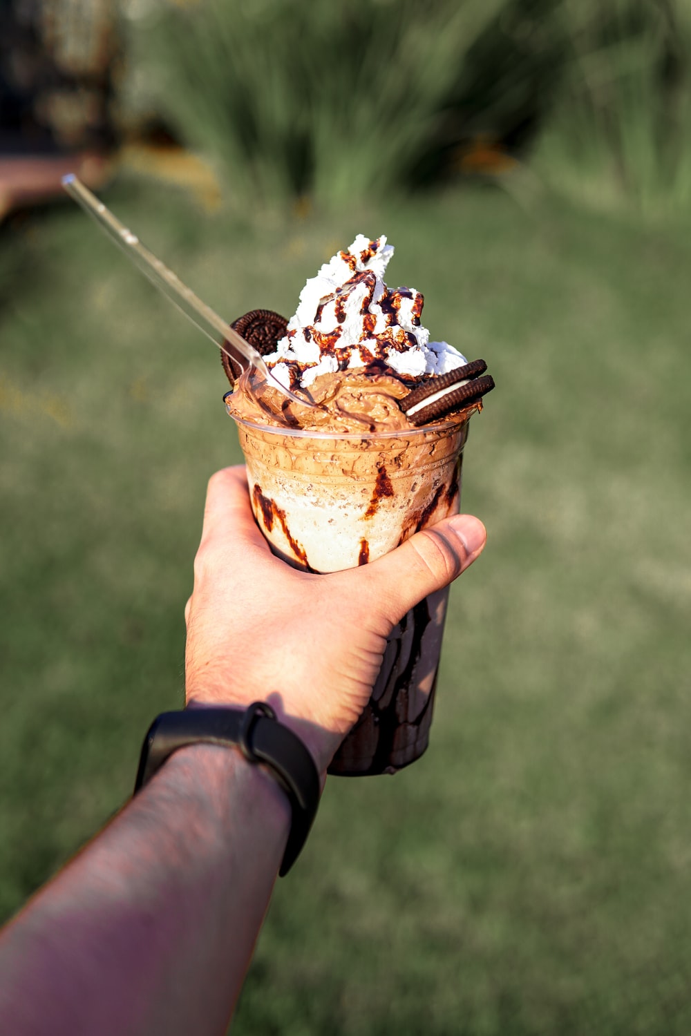 person holding ice cream cup photo