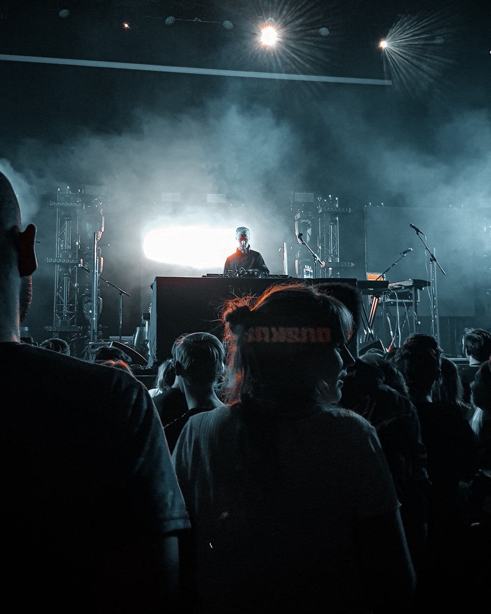 DJ performing on stage in front of people photo