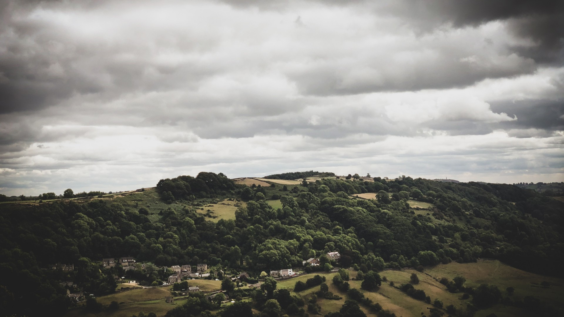 Download 1920x1080 Dark Weather, Hill, Trees, Houses, Scenic, Cloudy Wallpaper for Widescreen