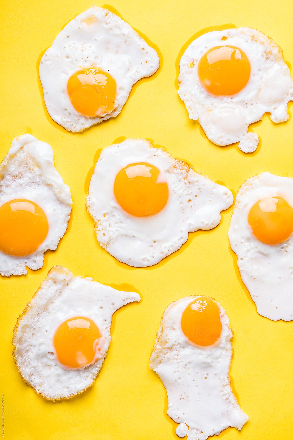 Fried Eggs On A Yellow Background.