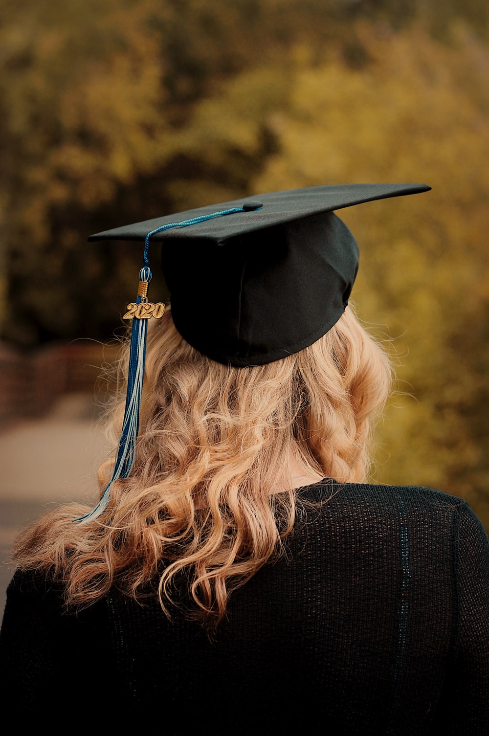 person holding graduation hat photo