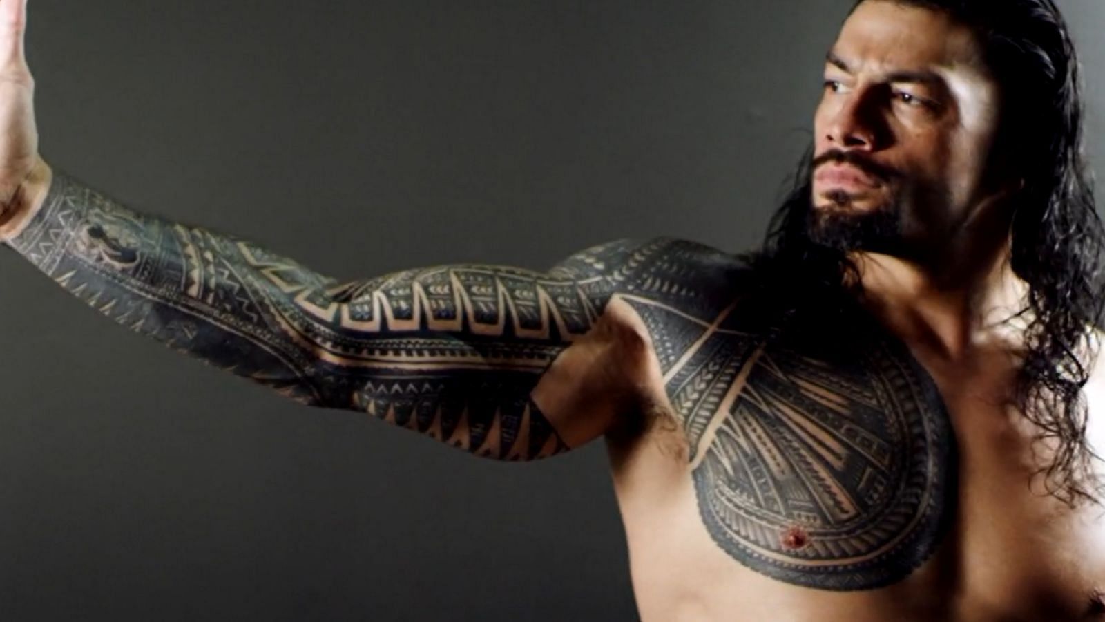 Who is Roman Reigns' tattoo artist?