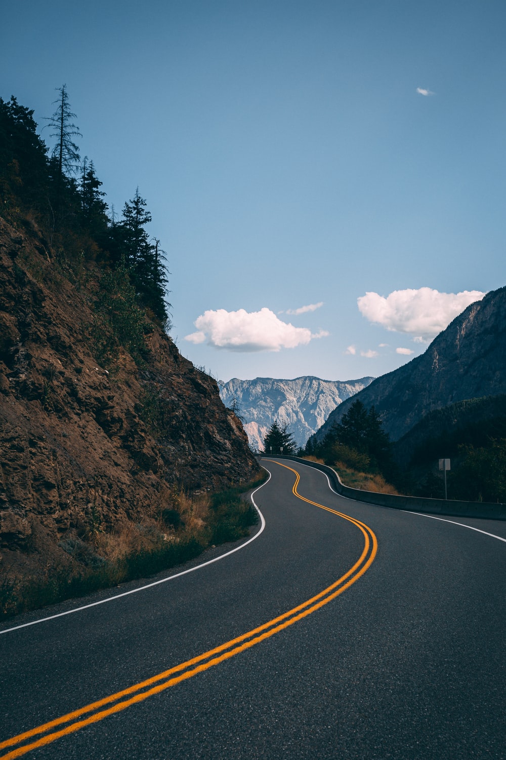 photo of road between mountain photo