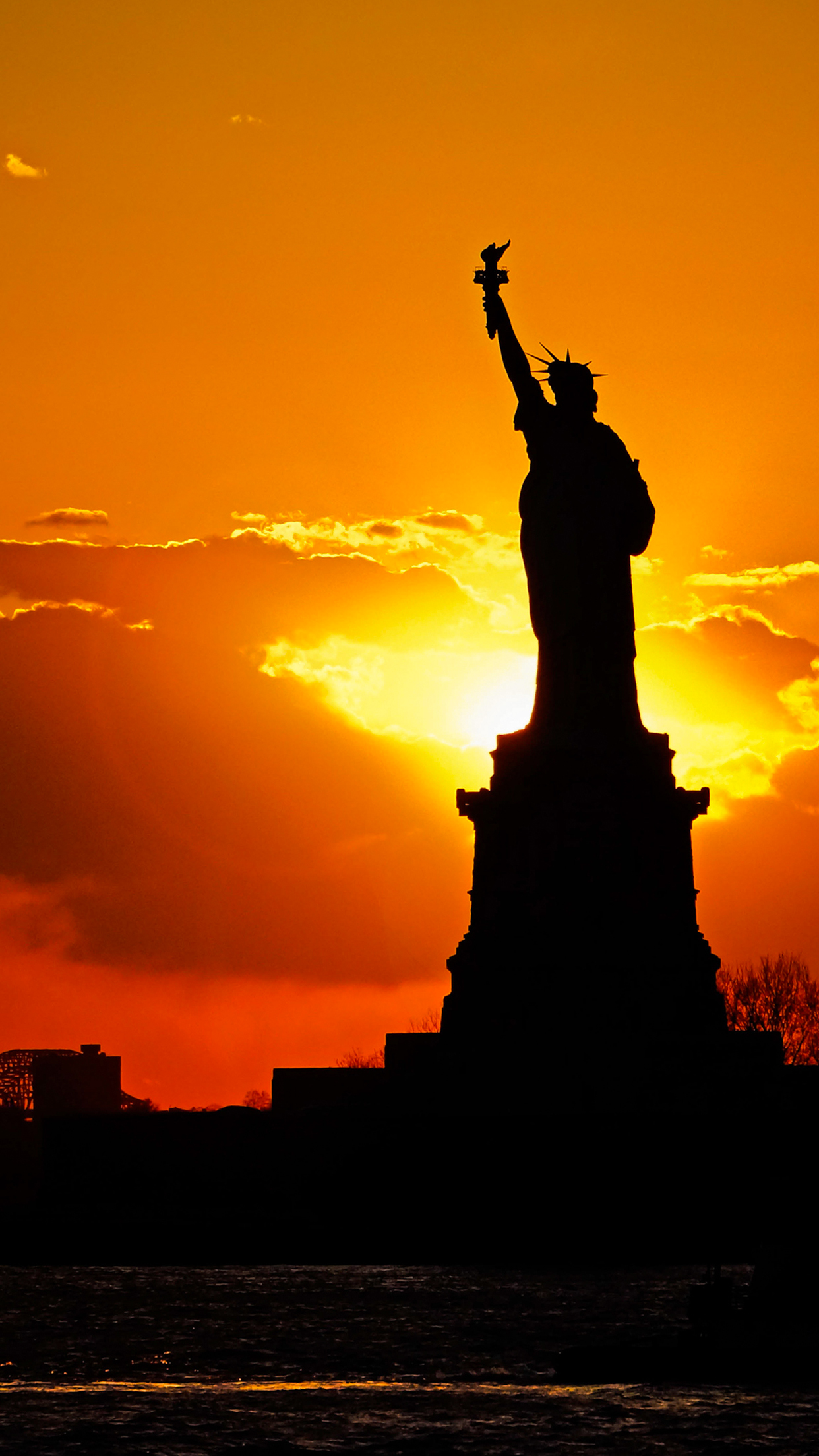 Sunset behind Statue of Liberty Wallpaper for iPhone Pro Max, X, 6