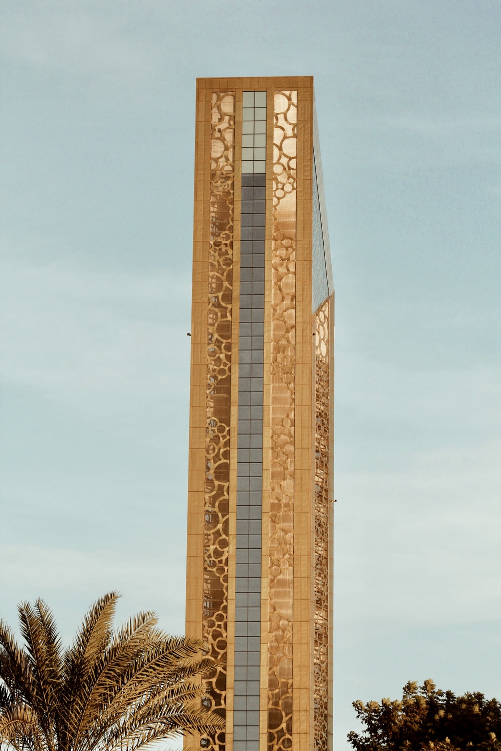 brown and white concrete building under blue sky during daytime photo