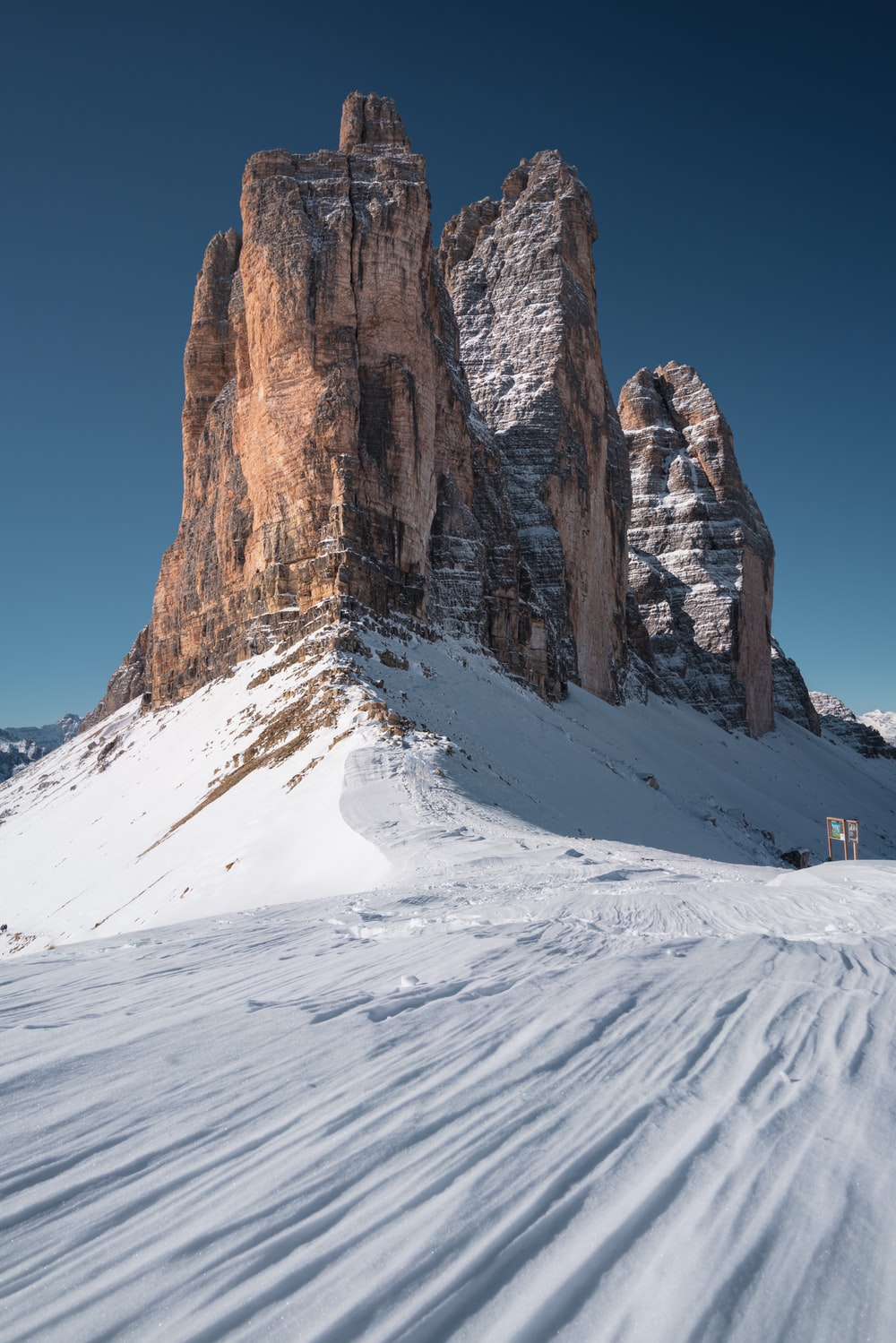 brown rocky mountain covered by snow during daytime photo