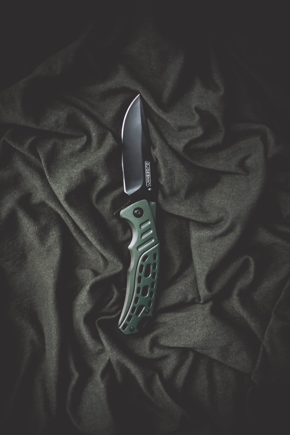 black and silver folding knife photo