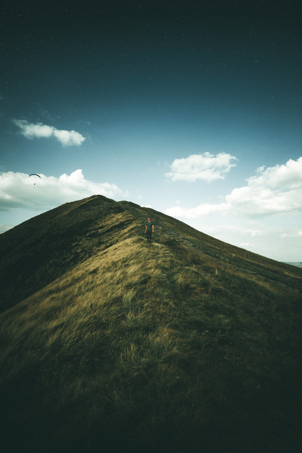 person on green grass mountain photo